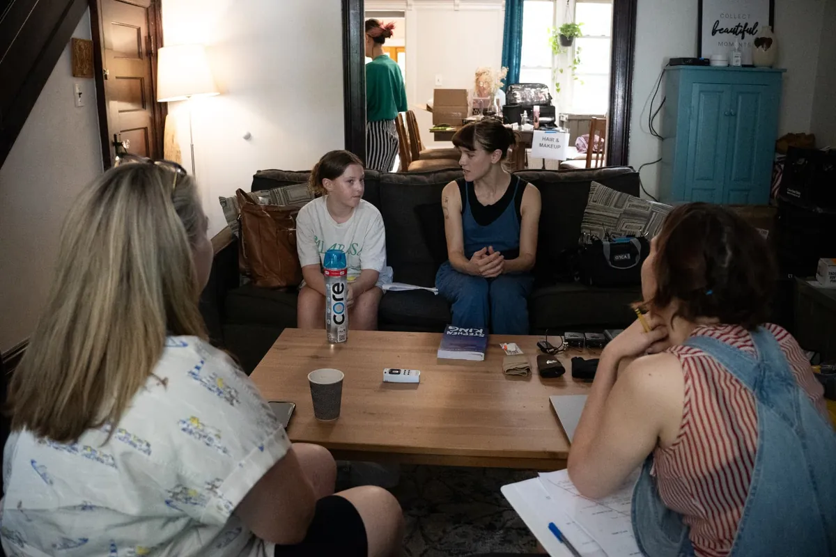 Behind the scenes — rehearsal in the living room with cast and crew