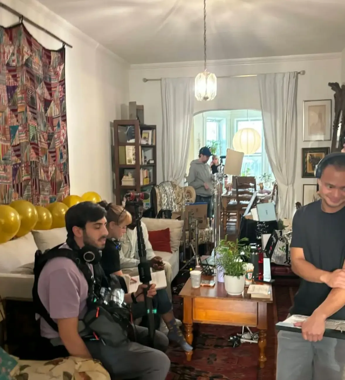 Behind the scenes on Divine Intervention — crew setting up the living-room set