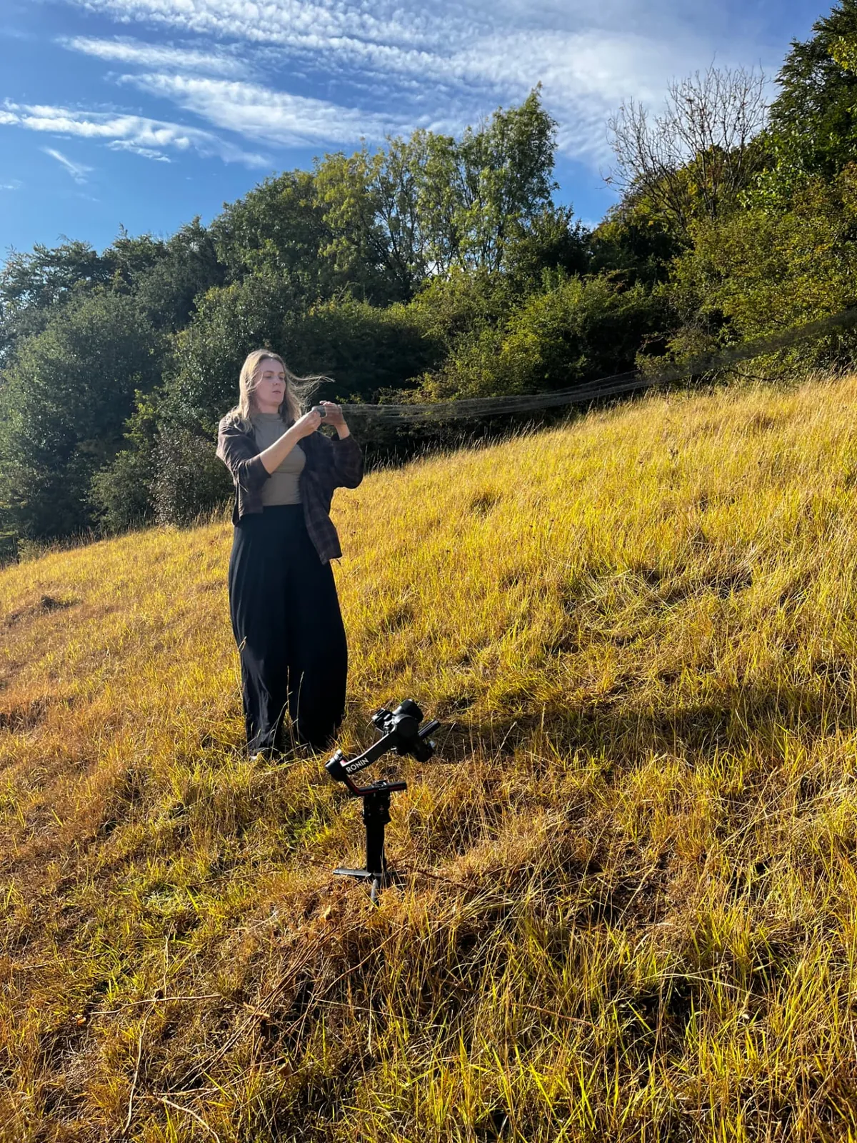 Setting up the gimbal on the hillside during filming