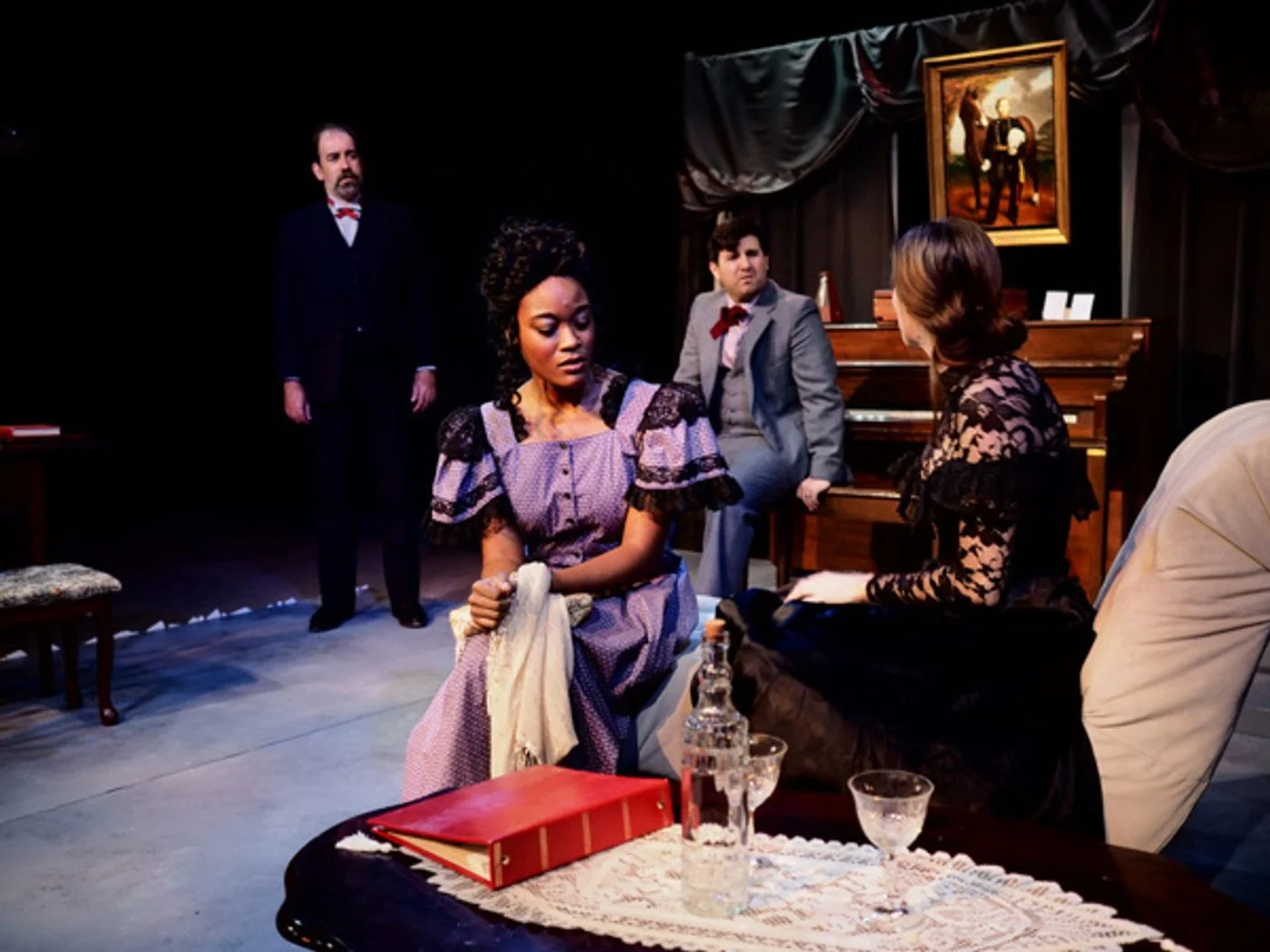 Judge Brack (Glenn Stoops), Thea Elvsted (Maya Carter), George Tesman (David De Almo), and Hedda Gabler (Kaitlyn Schirard)