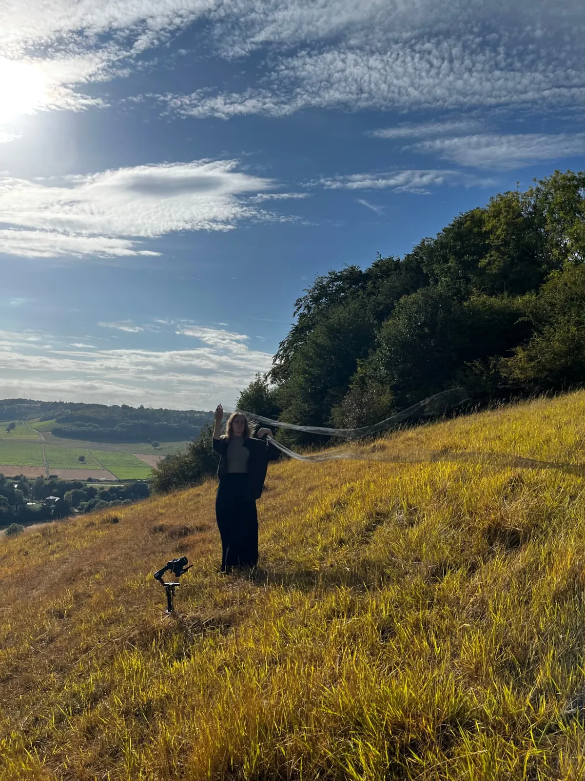 Aimee on the hillside at Box Hill with fabric catching the wind